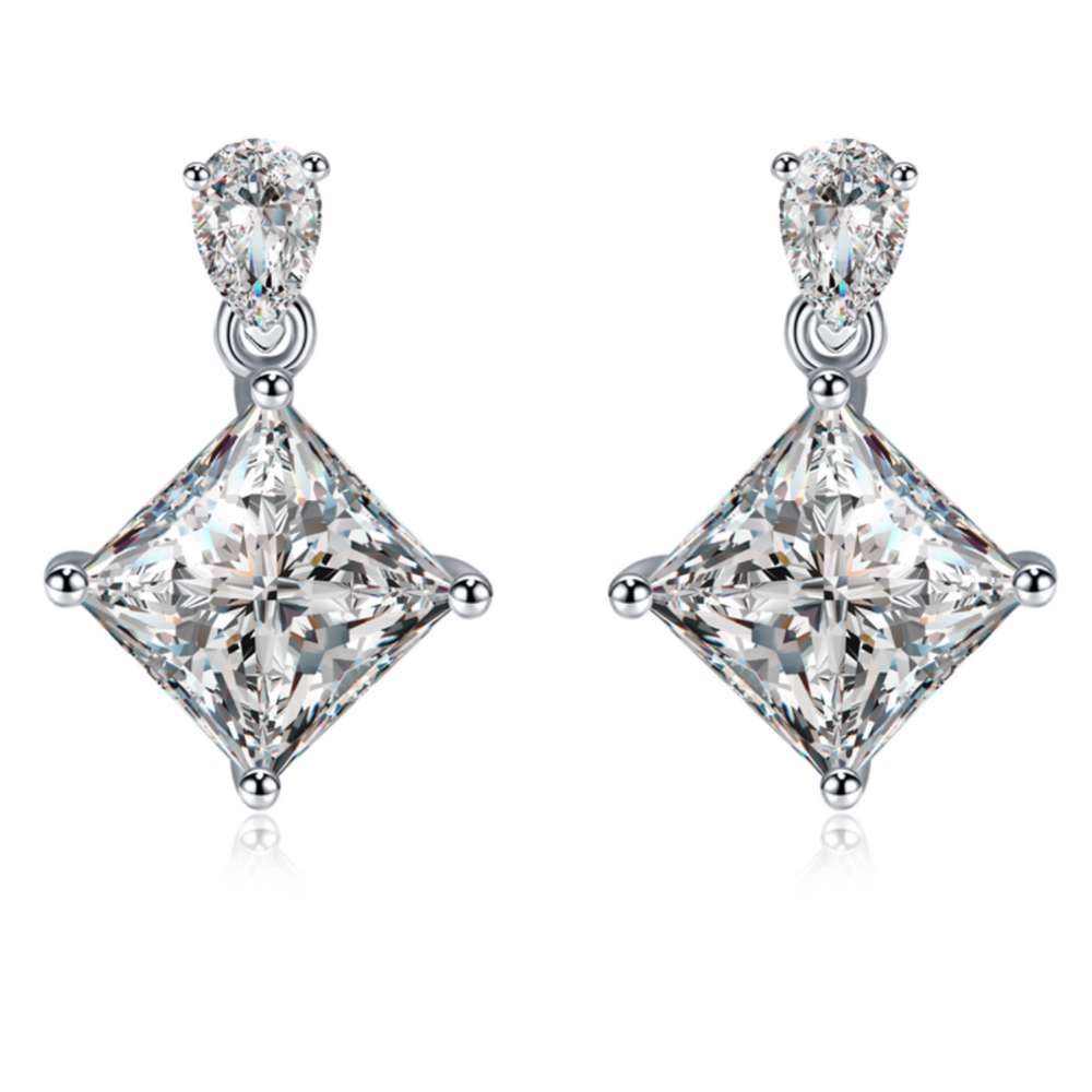 Moissanite stud earrings with a crystal prism-inspired design, showcasing dazzling, precisely cut stones set in a sleek metal frame for a modern, radiant look.