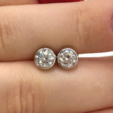 Moissanite stud earrings with a crystal symphony-inspired design, featuring radiant, precisely cut stones set in a sleek metal frame for a refined and luminous look.