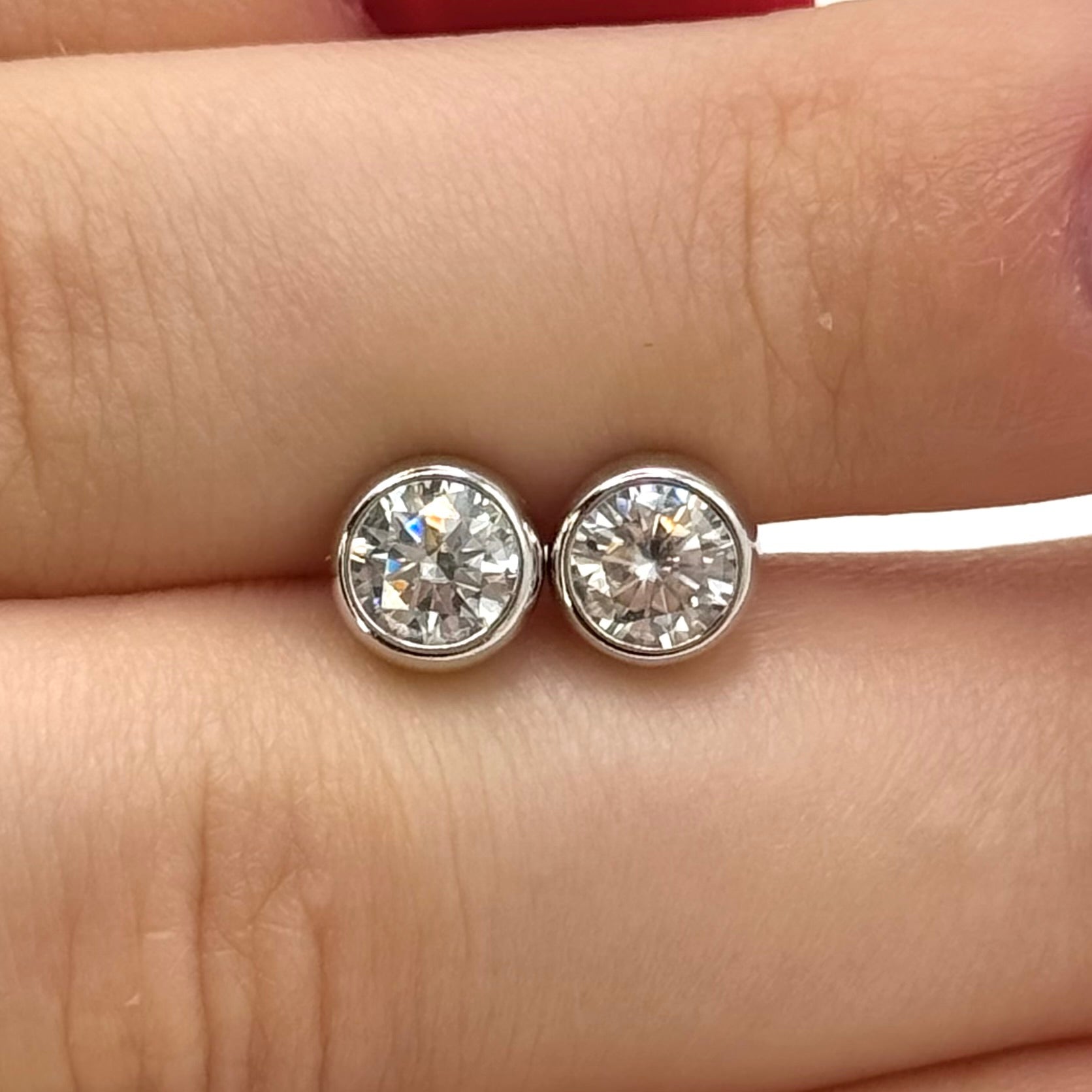 Moissanite stud earrings with a crystal symphony-inspired design, featuring radiant, precisely cut stones set in a sleek metal frame for a refined and luminous look.