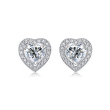 Moissanite stud earrings with a heartfelt design, featuring sparkling heart-shaped stones set in a polished metal frame for a timeless and elegant touch.