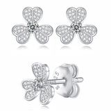 Moissanite stud earrings with a clover-inspired design, featuring sparkling stones arranged in a four-leaf pattern set in a polished metal frame for a timeless and elegant look.