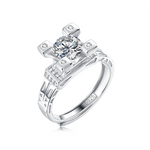 Moissanite ring with a diamond tower design, featuring a brilliant center stone elevated in a sleek metal setting for a bold and sophisticated look.