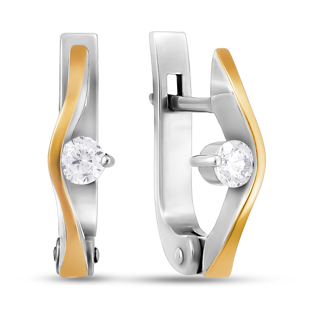 Pair of gold and silver earrings with clear gemstones on a white background