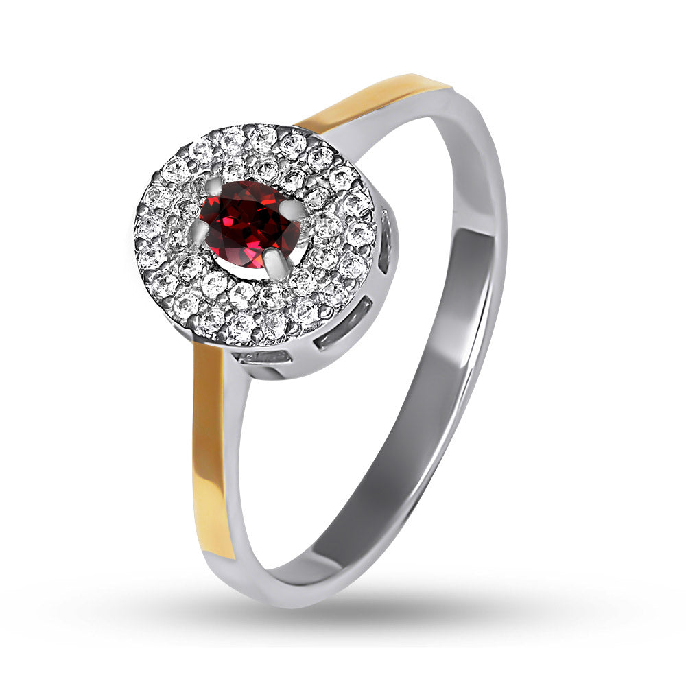 Ring with a red gemstone and diamond accents on a white background