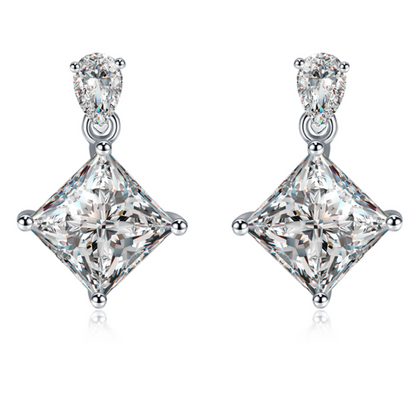Moissanite stud earrings with a crystal prism-inspired design, showcasing dazzling, precisely cut stones set in a sleek metal frame for a modern, radiant look.