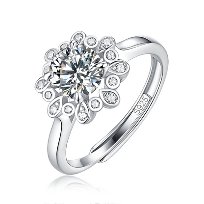 Moissanite ring with a starry blossom design, featuring a dazzling center stone surrounded by delicate accents set in a polished metal band for a radiant and elegant look.