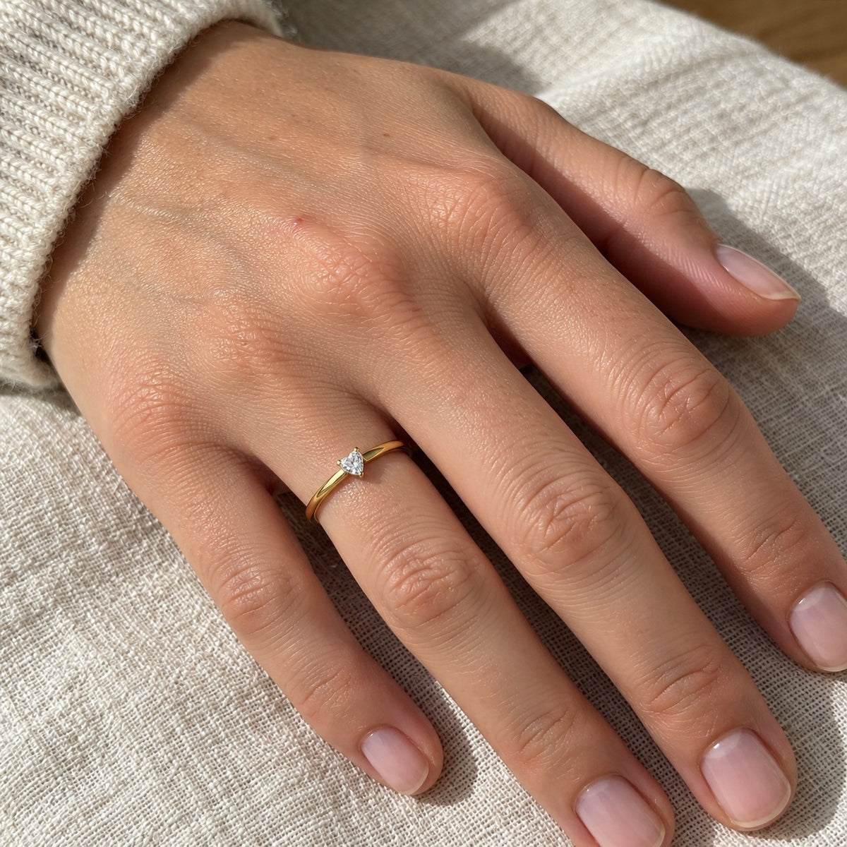 Golden Petite Promise ring worn on the hand, true-to-size