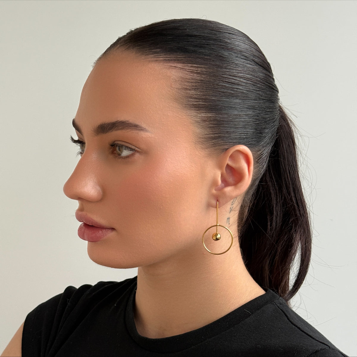 Golden Orbit Ball worn on model